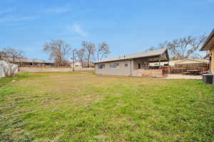 Back of property with a patio area and a shingled roof