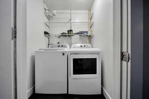 Laundry area featuring washer and dryer and baseboards