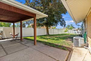 Fenced backyard with a patio