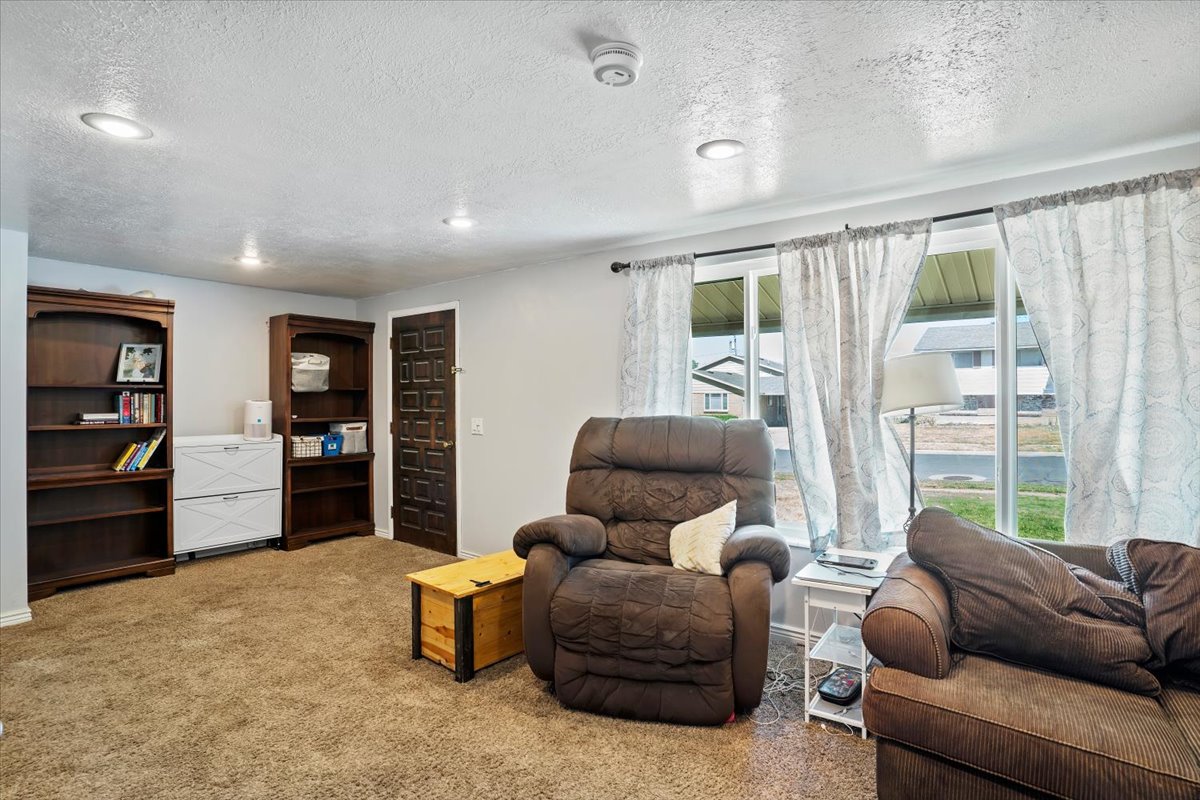 Sitting room featuring light carpet, a textured ceiling, and recessed lighting