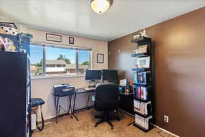 Office space featuring light carpet and baseboards