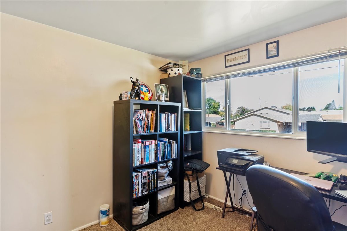 Office with light colored carpet and baseboards