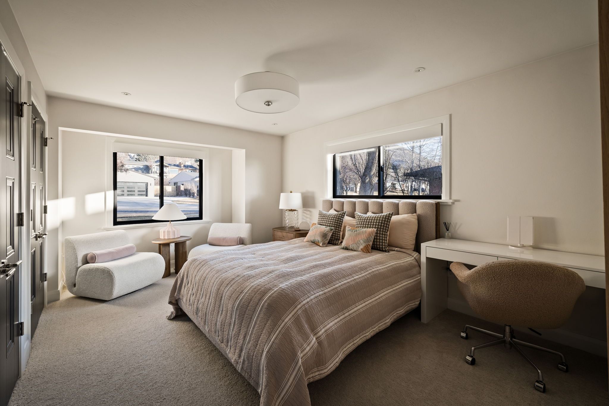 Bedroom with carpet, multiple windows, and an office area