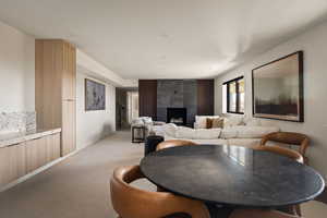 Dining area featuring carpet floors, a fireplace, and recessed lighting