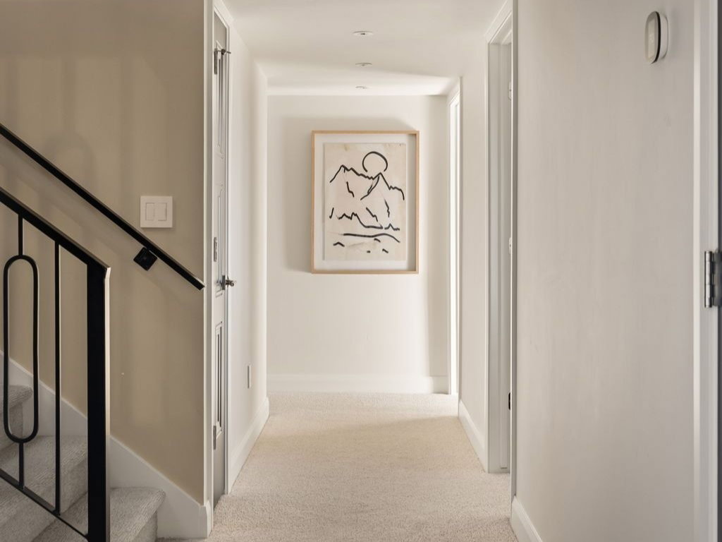 Hallway with carpet and stairs