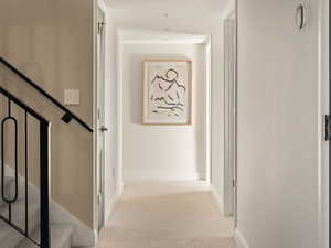 Hallway with carpet and stairs