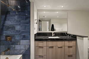 Full bathroom featuring vanity, shower / tub combination, and recessed lighting