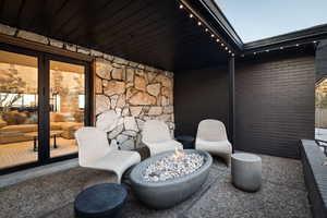 View of patio with an outdoor fire pit