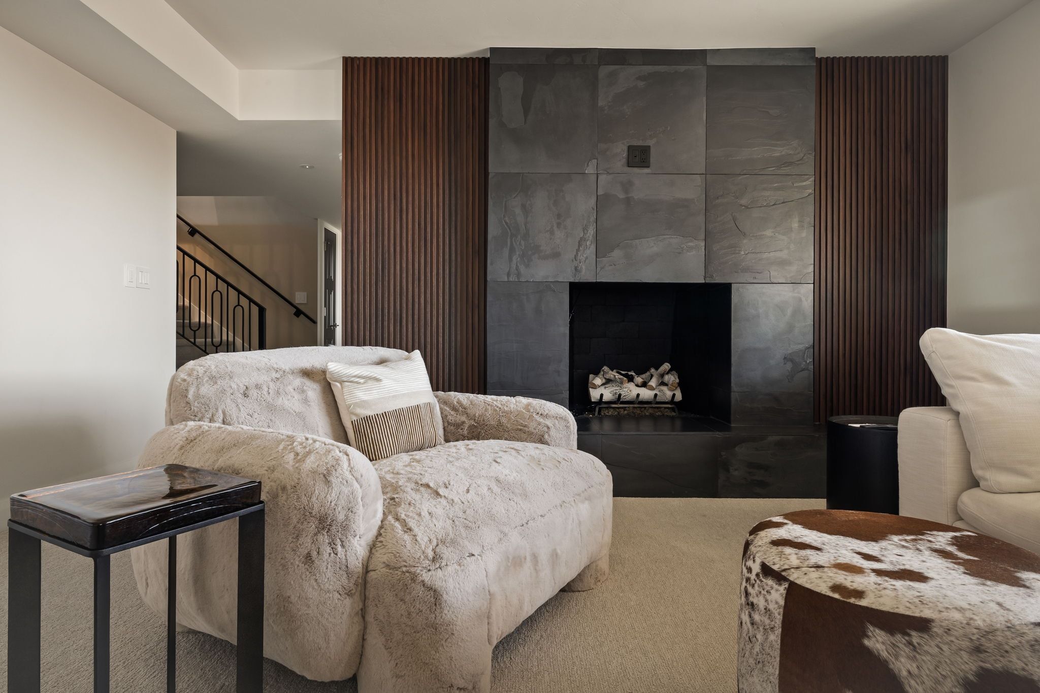 Sitting room with a tiled fireplace and carpet floors