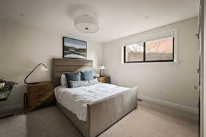 Carpeted bedroom featuring baseboards