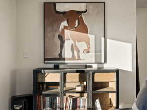 Bedroom with wood finished floors and baseboards