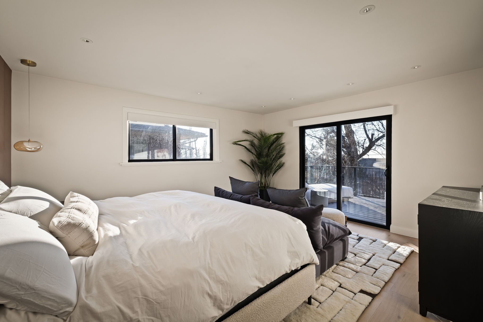 Bedroom featuring access to exterior and wood finished floors