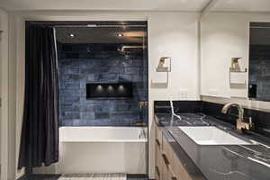 Bathroom with vanity and shower / bath combo