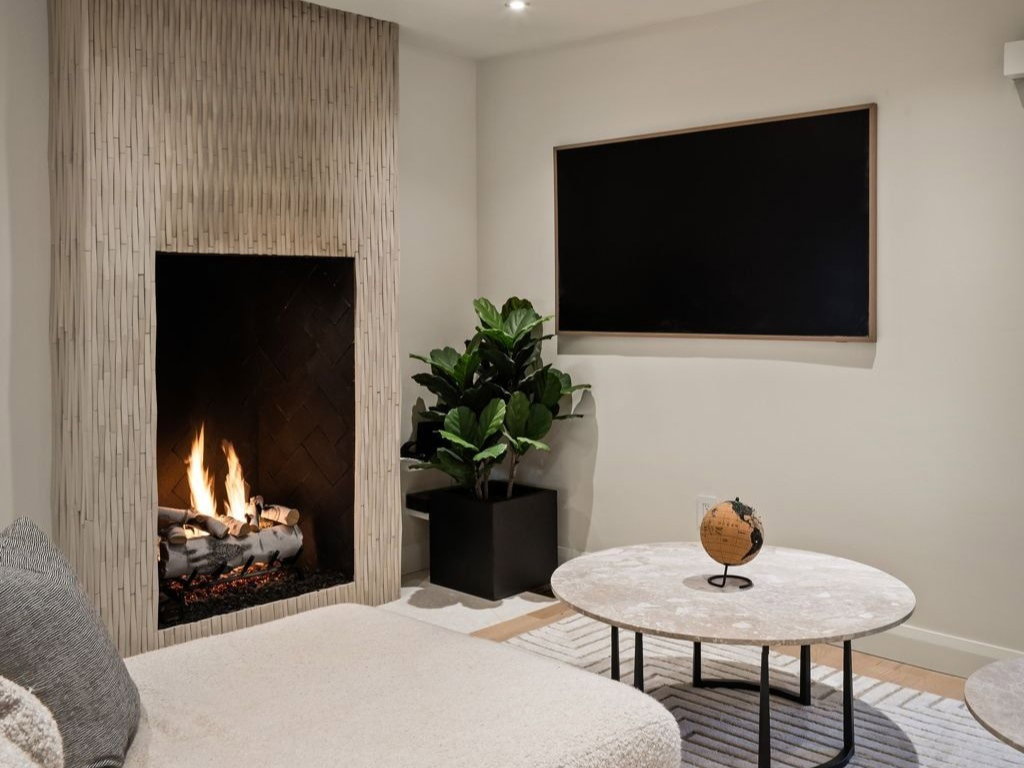 Living area featuring recessed lighting and a lit fireplace