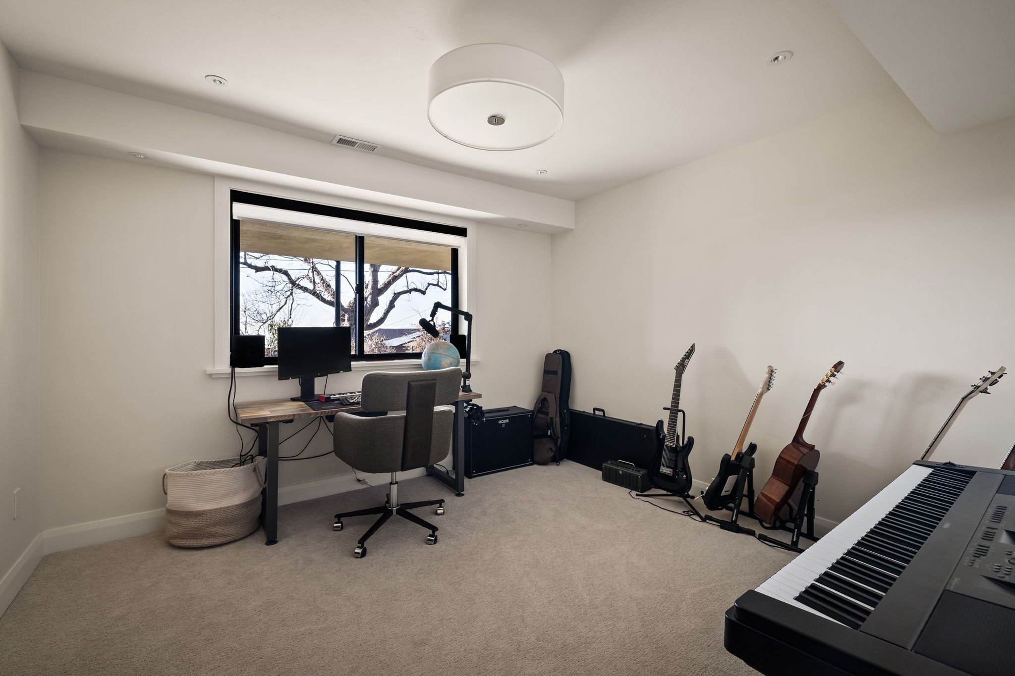 Office space with light carpet and baseboards