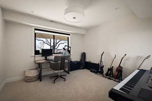 Office space with light carpet and baseboards