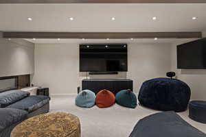 Carpeted living room featuring recessed lighting
