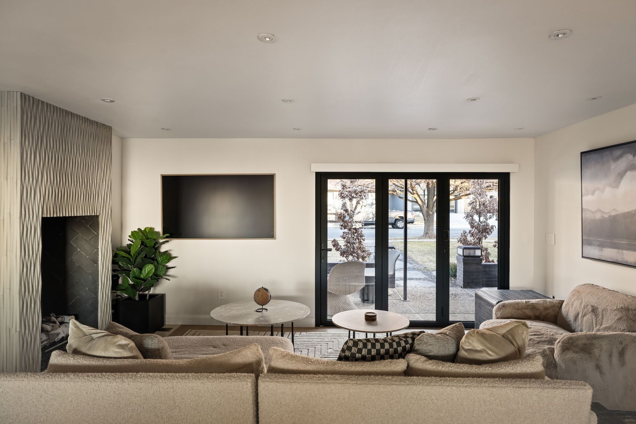 Living room with recessed lighting and a fireplace