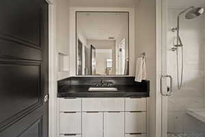 Full bathroom with a shower stall and vanity