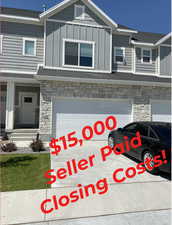 View of front of house featuring stone siding, board and batten siding, an attached garage, and concrete driveway