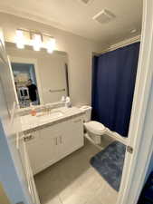 2nd Bathroom with our cleaner in the mirror checking our her work.