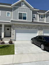 Craftsman house with stone siding, board and batten siding, and an attached garage