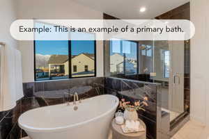 Bathroom with a stall shower, a soaking tub, and tile walls