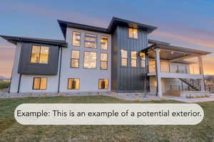 Back of house at dusk featuring board and batten siding, a patio, and a lawn