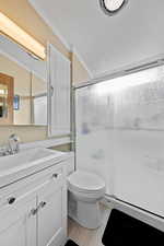 Full bath with a shower stall, vanity, crown molding, light wood-style floors, and a textured ceiling