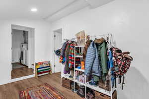 Mudroom featuring wood finished floors, vaulted ceiling, and recessed lighting