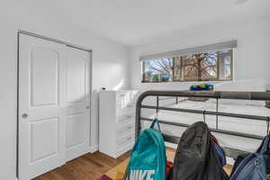 Bedroom with a closet and wood finished floors