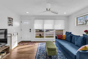 Living area with wood finished floors, ceiling fan, and recessed lighting