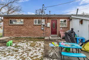 View of front facade with brick siding and a patio area
