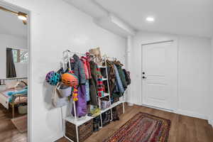 Mudroom featuring wood finished floors and lofted ceiling