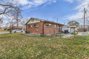 View of property exterior featuring brick siding and a patio