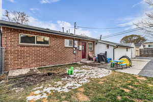 Rear view of house with a patio and brick siding