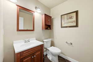 Bathroom with vanity and dark tile patterned floors