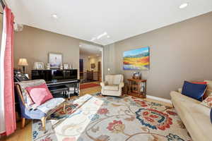 Living area featuring wood finished floors and recessed lighting