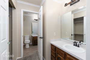 Bathroom with vanity and ornamental molding