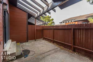 Fenced backyard with a patio area