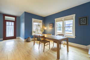 Dining room with light wood-style floors and baseboards