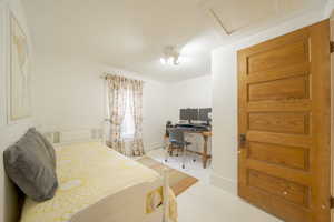 Bedroom featuring a desk and light wood-style floors