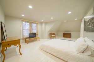 Bedroom with recessed lighting, hardwood / wood-style flooring, and lofted ceiling