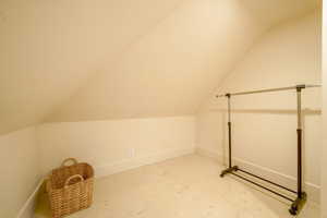 Bonus room with baseboards and vaulted ceiling