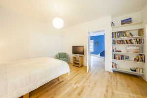 Bedroom featuring light wood finished floors and baseboards