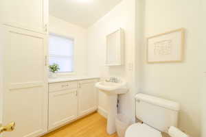 Bathroom featuring toilet and light wood finished floors