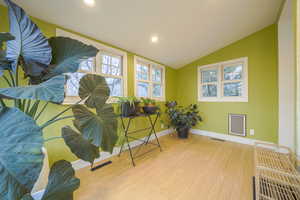 Living area featuring wood finished floors, recessed lighting, and lofted ceiling