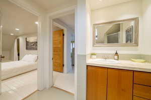 Ensuite bathroom featuring vanity and recessed lighting