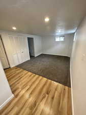 Below grade area featuring light wood finished floors and a textured ceiling