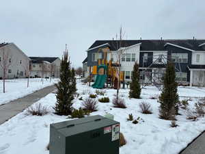 Snow covered playground with a residential view